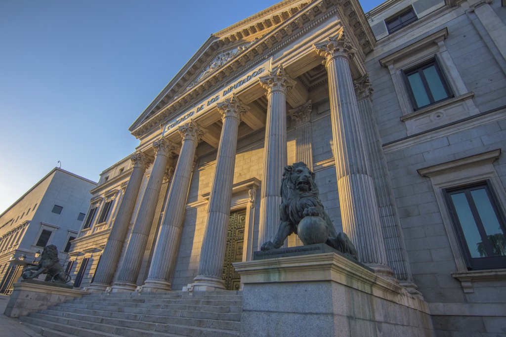 The Congress of Deputies of Spain at sunset without people against blue sky.