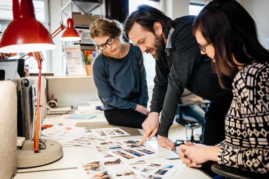 A group of people in their office reviewing part of their communication strategy.