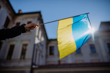 people-holding-ukrainian-flag-and-protesting-against-russian-invasion-in-ukraine-in-streets.jpg
