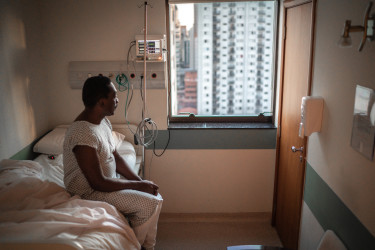 senior-patient-looking-through-window-at-hospital.jpg